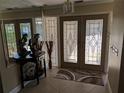 Bright entryway with double doors and decorative accents at 212 Poinciana Ln, Largo, FL 33770