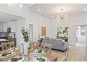 Bright dining room with wood table, chandelier, and view into kitchen at 3811 N Arlington Ave, Tampa, FL 33603