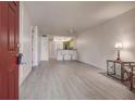 Open living room with kitchen and wood floors at 8302 Bardmoor Blvd # 202, Seminole, FL 33777