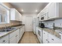 Kitchen with white cabinets, granite countertops, and appliances at 9016 Shallowford Ln # 202, Port Richey, FL 34668