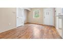 Dining room with wood-look flooring and access to kitchen at 9016 Shallowford Ln # 202, Port Richey, FL 34668