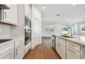 Modern kitchen with white cabinets, stainless steel appliances, and quartz countertops at 12620 Glenn Creek Dr, Riverview, FL 33569