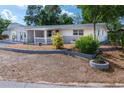 Landscaped yard with a charming house and driveway at 1537 Excalibur St, Holiday, FL 34690