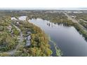 Aerial view of the property and surrounding neighborhood near the lake at 223 S Riverhills Dr, Temple Terrace, FL 33617