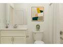 Clean bathroom with white vanity, toilet and a framed print at 31844 Cardinal Yard Dr, San Antonio, FL 33576