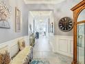 Bright entryway with seating and view to living area at 13444 Golden Lime Ave, Spring Hill, FL 34609