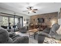 Comfortable living room with wood accent wall and sliding glass doors at 236 Caryl Way # 16, Oldsmar, FL 34677