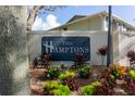 The Hamptons community sign surrounded by colorful landscaping and lush foliage at 237 Thorn Tree Pl # 237, Brandon, FL 33510