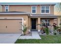 Two-story house with tan siding and a two-car garage at 36229 Jenny Lynne Cir, Zephyrhills, FL 33541