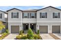 Three-unit townhouse building with attached garages at 3632 Bellmeade Ct, Wesley Chapel, FL 33543