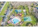 Aerial view of community amenities including pool, tennis, basketball, and playground at 3632 Bellmeade Ct, Wesley Chapel, FL 33543