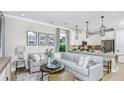 Open living room with L-shaped sofa and kitchen views at 748 Steel Dr, Apollo Beach, FL 33572