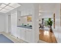 Kitchen boasts white cabinets, a breakfast bar, and views into the living area at 8014 Peach Dr, Temple Terrace, FL 33637