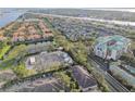Aerial view of community, featuring multiple buildings, landscaping, and waterways at 901 Normandy Trace Rd, Tampa, FL 33602