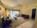 Spacious living room with light beige carpet and a view to the backyard at 1404 Woodstream Dr, Oldsmar, FL 34677