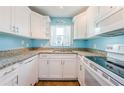 Bright kitchen with white cabinets and granite countertops at 211 S Mcmullen Booth Rd # 189, Clearwater, FL 33759