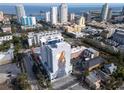 Wide aerial shot of the condominium building surrounded by cityscape and ocean views on a sunny day at 226 5Th N Ave # 706, St Petersburg, FL 33701