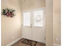 Inviting entryway with double doors and tile flooring at 33536 Westwood Dr, Dade City, FL 33523