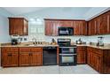Well-equipped kitchen, offering ample cabinetry and granite countertops at 3647 Muirfield Ct, New Port Richey, FL 34655