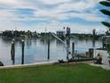 Scenic waterfront view with boat lift and grassy area at 16126 4Th E St, Redington Beach, FL 33708