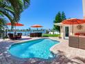 Relaxing pool area with patio furniture and waterfront view at 16126 4Th E St, Redington Beach, FL 33708