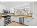 Modern kitchen with granite countertops and stainless steel appliances at 303 Windrush Loop, Tarpon Springs, FL 34689