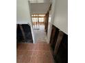 Damaged hallway with tiled floor leading to other rooms at 319 80Th Ne Ave, St Petersburg, FL 33702