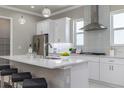Bright kitchen boasts white cabinets, stainless steel appliances, and an island at 3845 Seena Manor Ct, Tampa, FL 33618