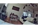 Living room featuring hardwood floors, a ceiling fan, and contemporary decor at 10006 N Mitchell Ave, Tampa, FL 33612