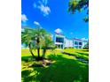 Bright exterior view showcasing balconies and manicured lawns under a brilliant blue sky at 2060 Marilyn St # 239, Clearwater, FL 33765