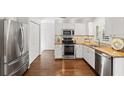 Modern kitchen with stainless steel appliances and butcher block counters at 2457 Hickman Cir, Clearwater, FL 33761