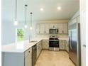 Modern kitchen with stainless steel appliances and white countertops at 285 Porto Alegre St, Punta Gorda, FL 33983