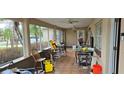 Enclosed porch with tiled floor and seating at 7054 Hibiscus S Ave, South Pasadena, FL 33707