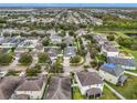 Aerial view showcasing a residential area with houses, streets, and green spaces at 11539 Balintore Dr, Riverview, FL 33579