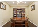 Spacious home office with built-in bookcases and a large desk at 1433 Emerald Hill Way, Valrico, FL 33594