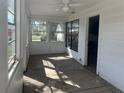 Bright sunroom with multiple windows and a ceiling fan at 1757 New Hampshire Ne Ave, St Petersburg, FL 33703