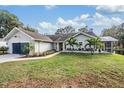 Front view of a charming house with landscaping at 18212 Oakdale Rd, Odessa, FL 33556