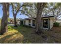 View of the house from the side, highlighting the landscaping at 2227 Willowbrook Dr, Clearwater, FL 33764