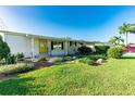 House exterior showcasing a well-maintained lawn and vibrant landscaping at 36730 Tara Ave, Zephyrhills, FL 33542