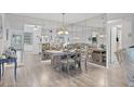 Bright dining room with light wood floors and a table for four at 5720 13Th N Ave # 203B, St Petersburg, FL 33710
