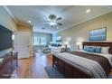 Spacious main bedroom featuring a king bed, lounge area, wood floors and an abundance of natural light at 94 The Cove Way, Indian Rocks Beach, FL 33785