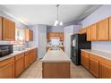 Kitchen with island, wood cabinets, and stainless steel appliances at 2102 Deltona Blvd, Spring Hill, FL 34606
