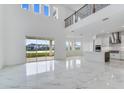 Open living area with high ceilings, marble floors, and a view of the water at 33874 Galley Way, Wesley Chapel, FL 33543