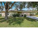 Ranch-style home nestled on a spacious lot with lush landscaping at 4175 103Rd N Ave, Clearwater, FL 33762