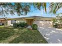 Well-maintained house with a two-car garage and manicured lawn at 4175 103Rd N Ave, Clearwater, FL 33762