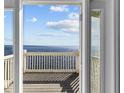 Stunning water view from a balcony with white railing and wooden deck at 5026 Coquina Key Se Dr # 5026, St Petersburg, FL 33705