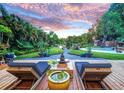 Serene backyard oasis with deck, pond view, and relaxing seating area at 1560 53Rd N St, St Petersburg, FL 33710