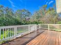 Wooden deck with white railing overlooking the backyard at 364 Terrace Rd, Tarpon Springs, FL 34689