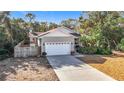 Single-story house with a two-car garage and landscaped yard at 364 Terrace Rd, Tarpon Springs, FL 34689