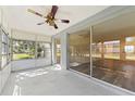 Bright sunroom with sliding glass doors leading to backyard and ceiling fan at 4220 Sheldon Pl # 4220, New Port Richey, FL 34652